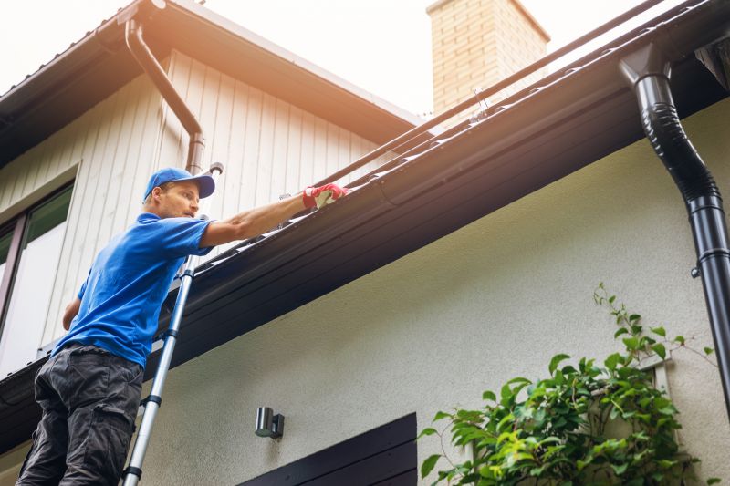 Maintenance Technician Inspecting Gutter Covers